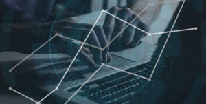 image of hands on laptop with graph overlaid on top